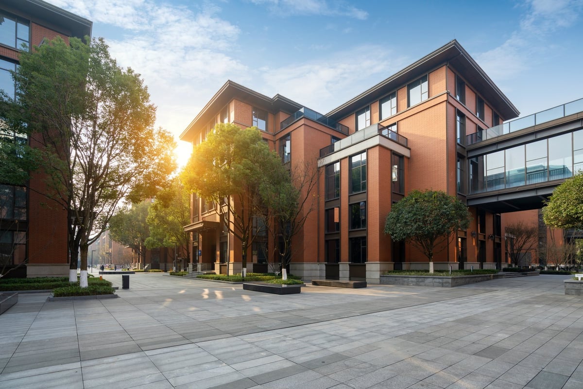 Red-brick buildings set within a green park in a British city