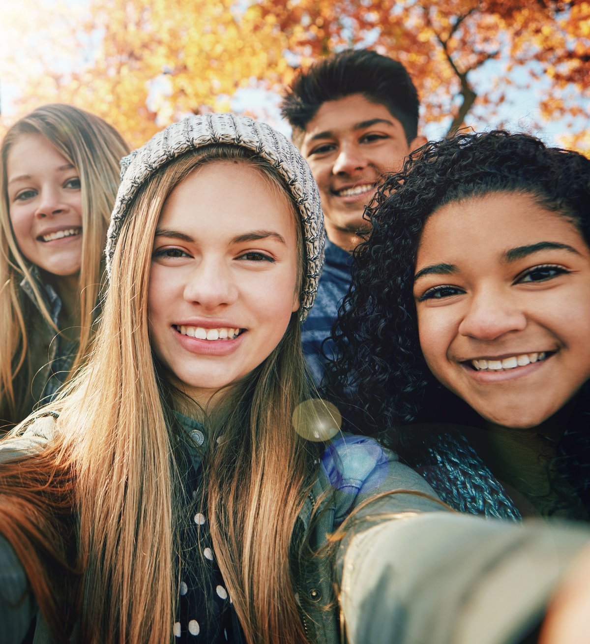 A group of friends smiling for a photo during a student trip